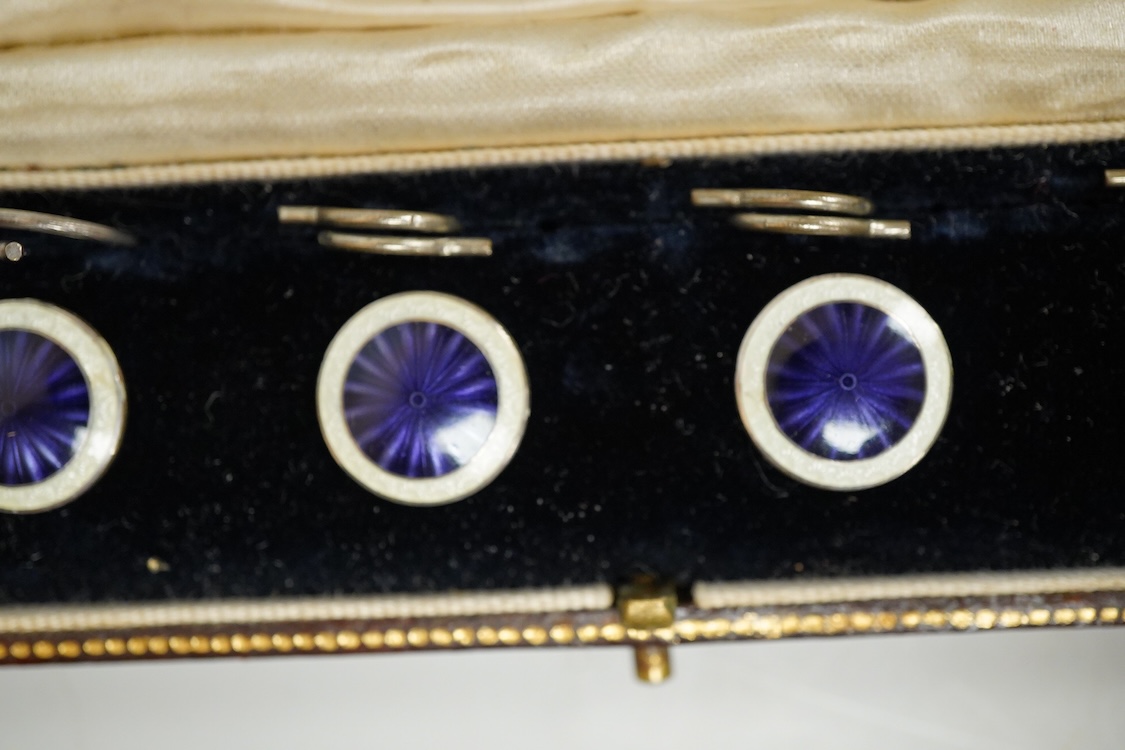 A set of four silver and two colour enamel buttons, by Lawson, Ward & Gammage Ltd, Birmingham, 1910, diameter 12mm, in original gilt tooled leather case by Rowell & Son Ltd of Oxford.